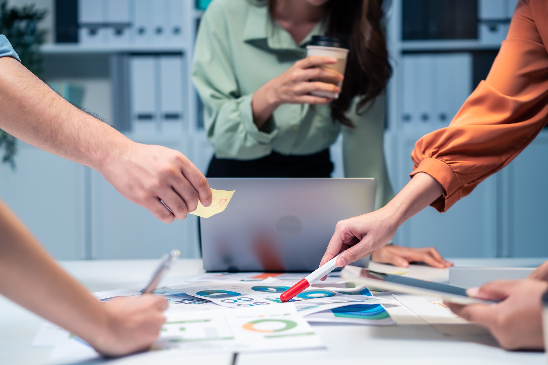 Close up hands of businessman and woman people group meeting in office. Employee brainstorm and work as team, plan and discuss project by point on paper. Corporate of modern colleagues or coworkers.